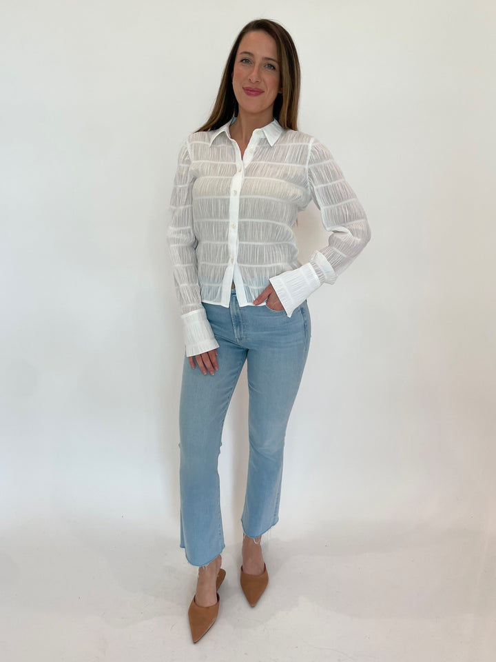 Frame The Smocked Shirt in White paired with Mother The Hustler Ankle Fray Jeans in Ball's In Your Court wash available at Barbara Katz