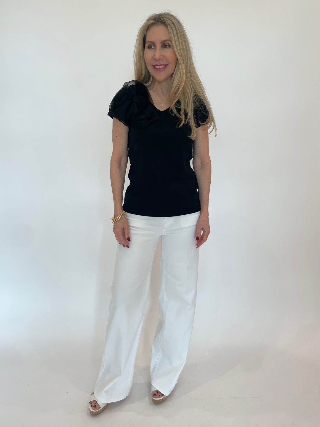 Bariloche Inca Flower Top in Black paired with Frame Le Slim Palazzo Jeans in White available at Barbara Katz