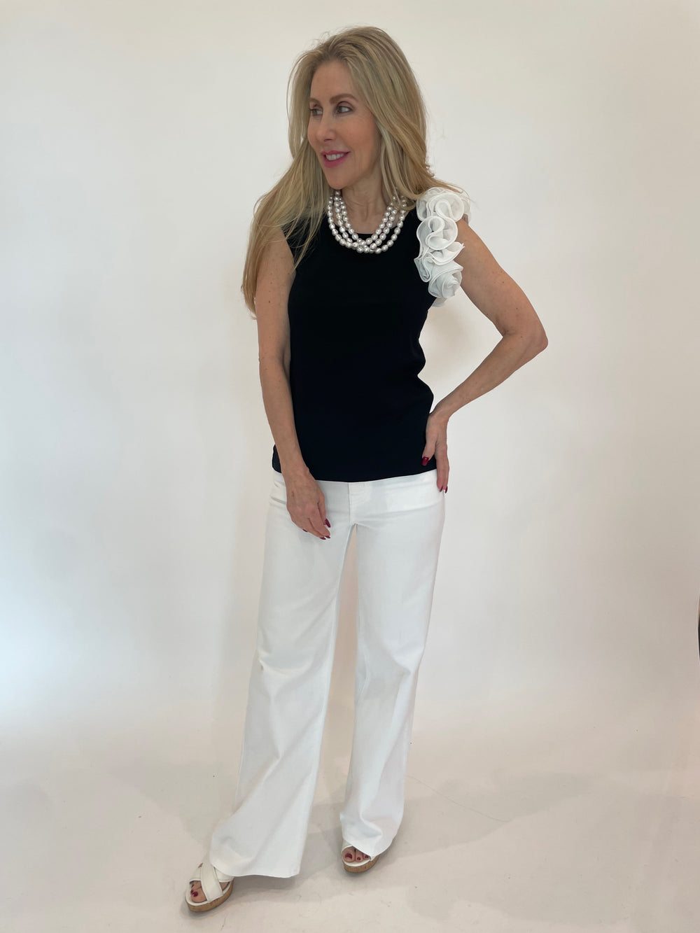 Bariloche Apumer Rose Top in Black paired with Frame Le Slim Palazzo Jeans in White available at Barbara Katz