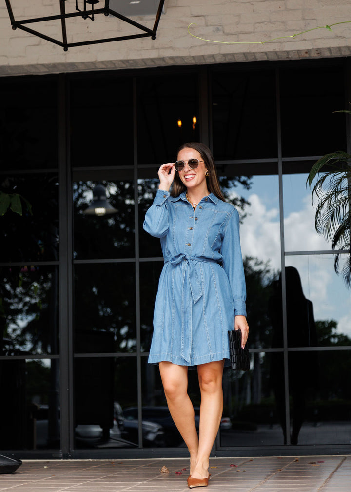 Hinson Wu Sabrina Long Sleeve Denim Dress in inMedium Wash paired with Le Specs Neptune Deux Sunglasses and Remi/Reid Lindy Large Woven Clutch Bag in Black available at Barbara Katz 