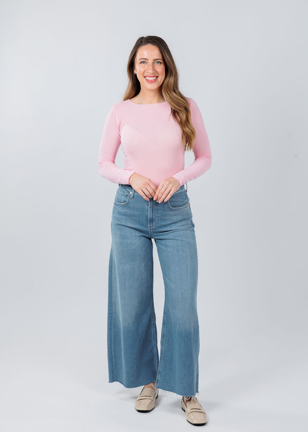 AMB Designs Solid Raw Edge High Neck Second Skin Top in Candy Pink paired with Citizens of Humanity Lyra Crop Wide Leg Jeans in Bhodi available at Barbara Katz