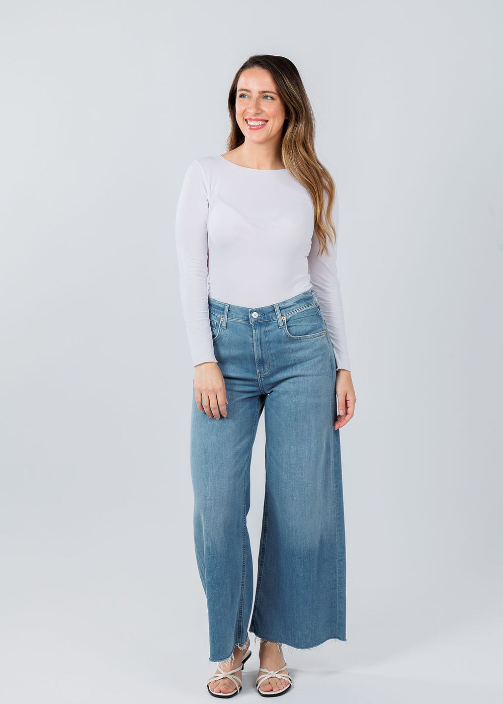 AMB Designs Solid Raw Edge High Neck Second Skin Top in White paired with Citizens of Humanity Lyra Crop Wide Leg Jeans in Bhodi available at Barbara Katz