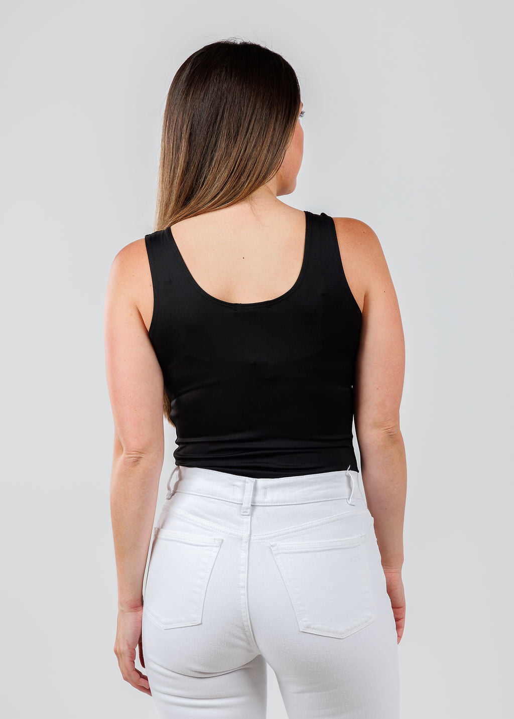 A'NUE The Classic Micro Tank Top in Black featuring a scoop neckline, wide shoulder straps, form-fitting fit, travel-friendly style available at Barbara Katz.