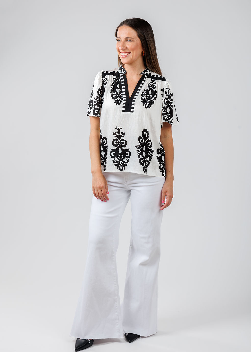 BK Embroidered Split Neck Top in White/Black paired with Pistola Denim Izzy Wide Leg Crop Jeans in Vivid White available at Barbara Katz