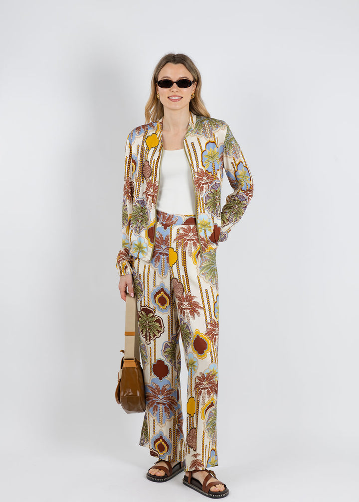 Bariloche Tuvalu Printed Silky Bomber Jacket paired with Bariloche Tojo Palm Printed Pants in Chocolate available at Barbara Katz