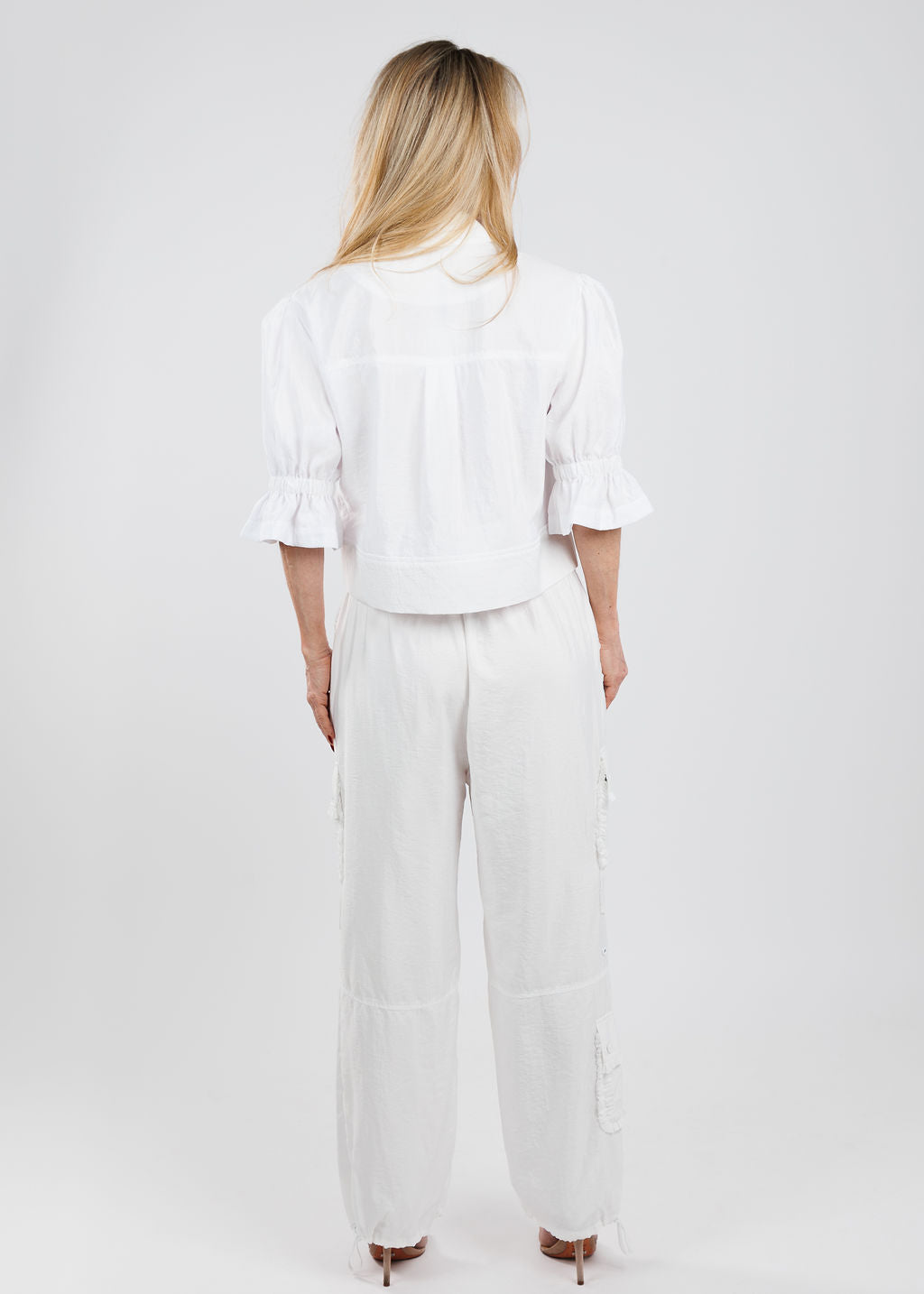 Cinq a Sept Holly Parachute Jacket in White paired with matching Cinq a Sept Nitsan Ruffle Parachute Pants in White available at Barbara Katz