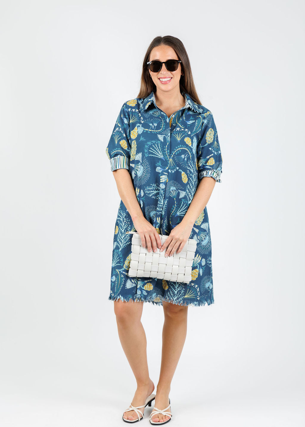 Dizzy-Lizzie Chatham Dress in Blue Underwater Print paired with Remi/Reid Nieves Woven CLutch Bag in White available at Barbara Katz
