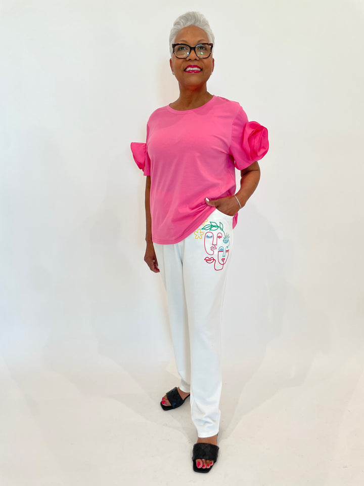 Leo & Ugo Taty Rose Flower Top in Pink paired with Leo & Ugo Dominic Faces Pants in White available at Barbara Katz