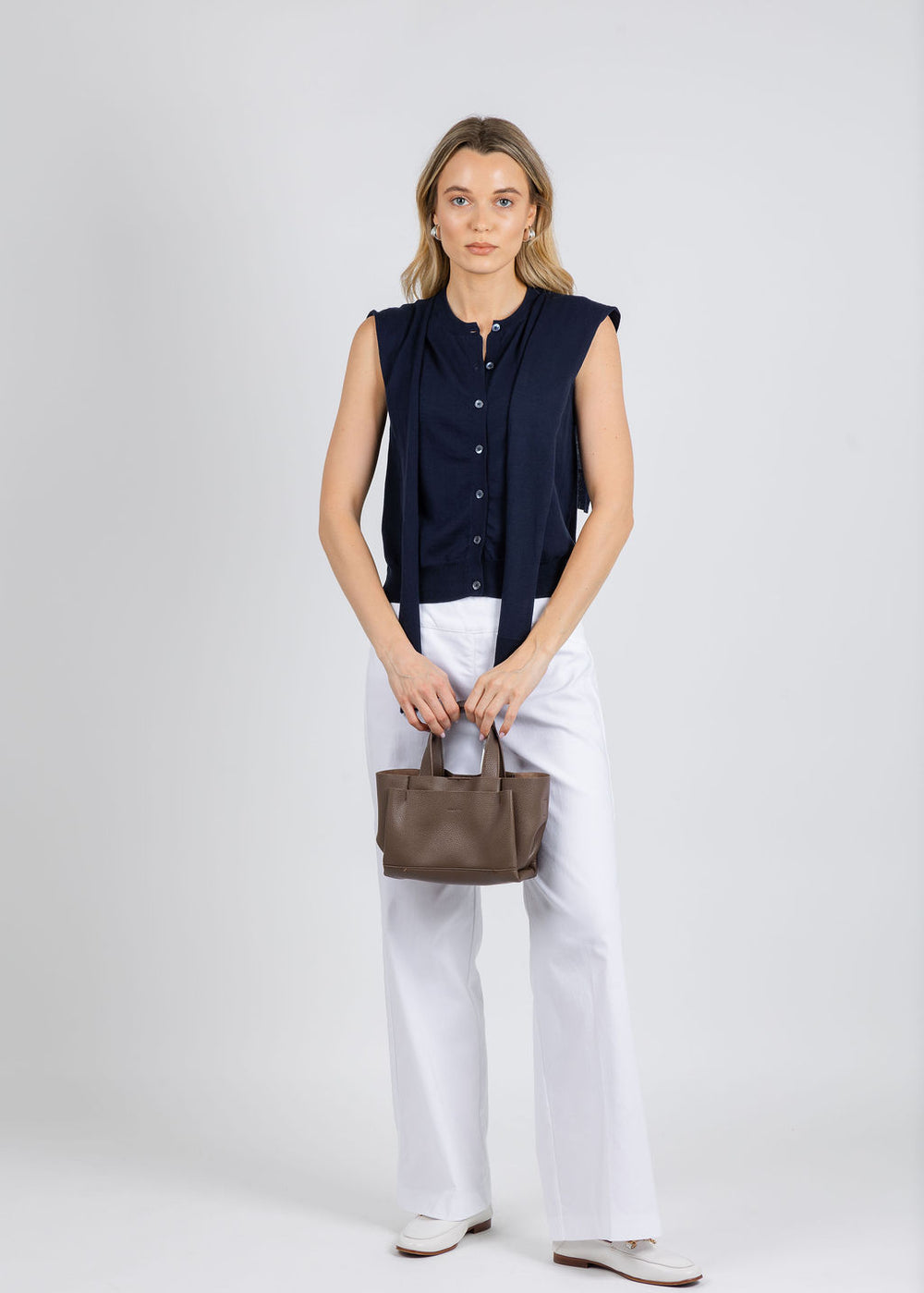 Autumn Cashmere Button Front Vest With Tie Sleeve in Navy paired with Elliott Lauren 30" Control Stretch Wide Leg Pants in White available at Barbara Katz
