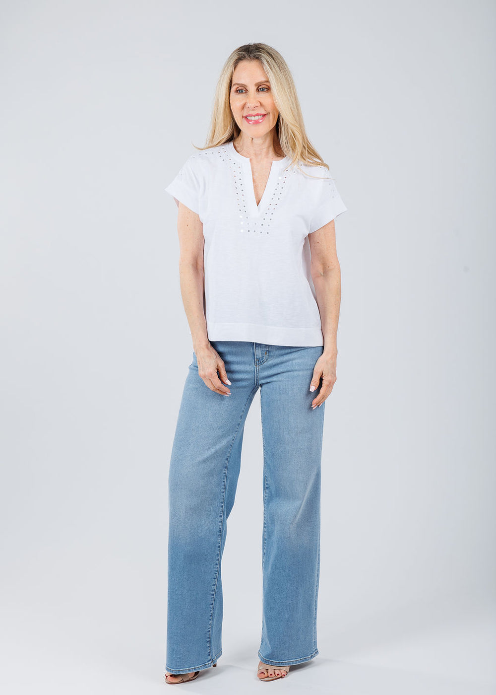 Elliott Lauren Ramy V-Neck Top With Mirror Sequin Detail in White paired with Frame Le Slim Palazzo Jeans in Honeymoon available at Barbara Katz