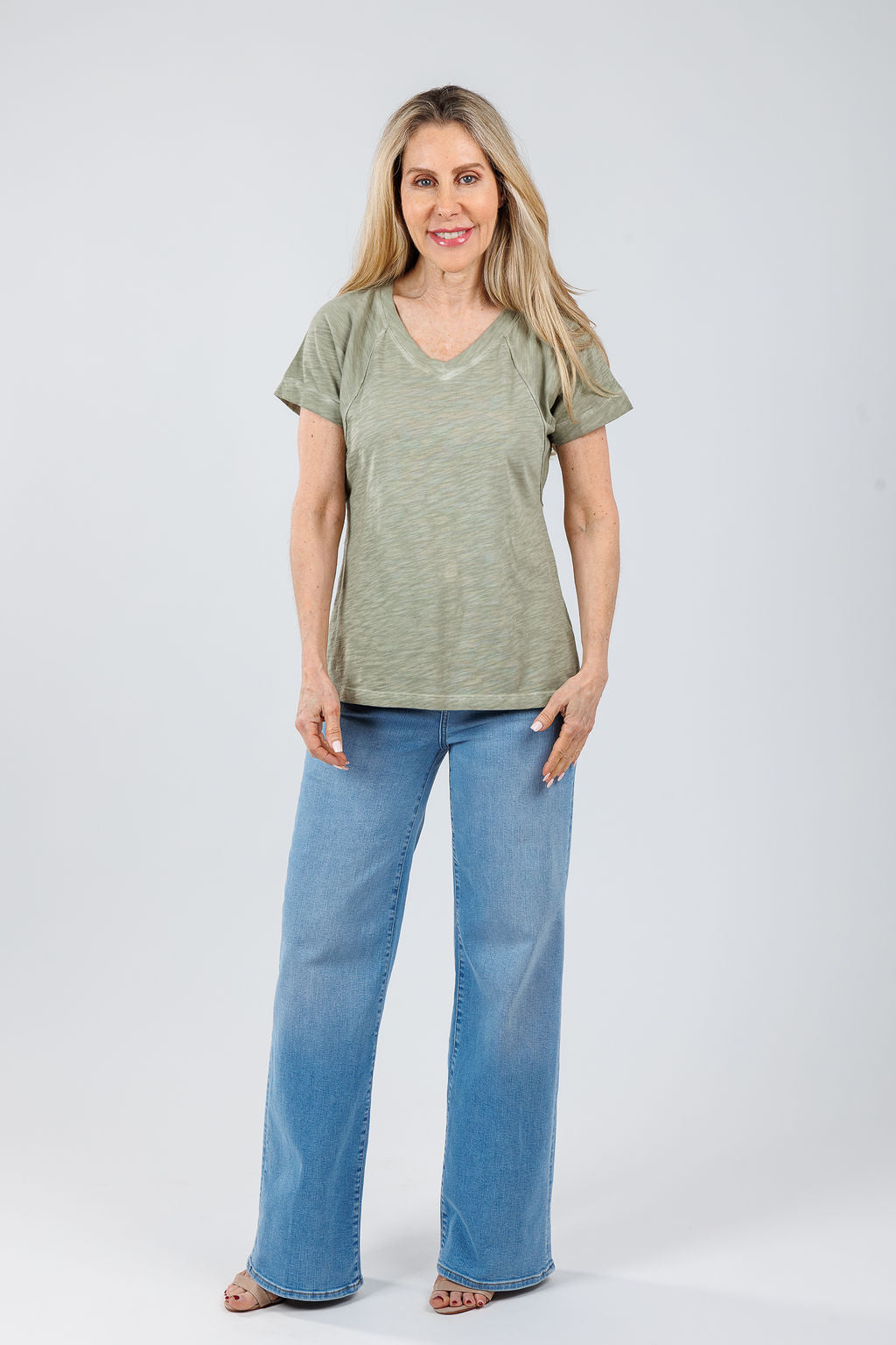 Elliott Lauren Tina Raglan Short Sleeve V-Neck Tee in Thyme paired with Frame Le Slim Palazzo Jeans in Honeymoon available at Barbara Katz