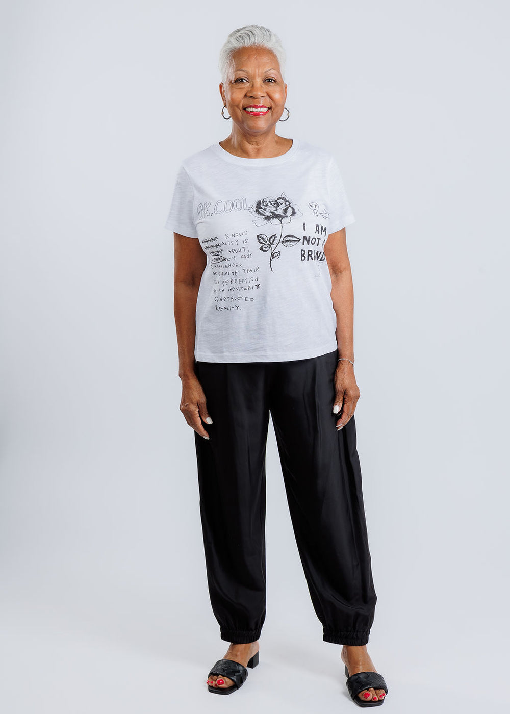 Elliott Lauren Graffiti Short Sleeve Graphic Tee in White paired with Marella Abetaia Joggers in Black available at Barbara Katz