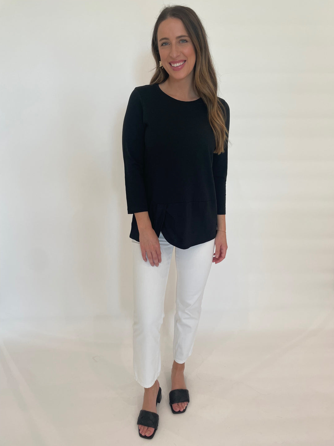 E.L.I Laila 3/4 Sleeve Twist Top in Black paired with Straight Jeans in White available at Barbara Katz