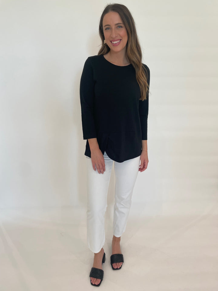 E.L.I Laila 3/4 Sleeve Twist Top in Black paired with Straight Jeans in White available at Barbara Katz