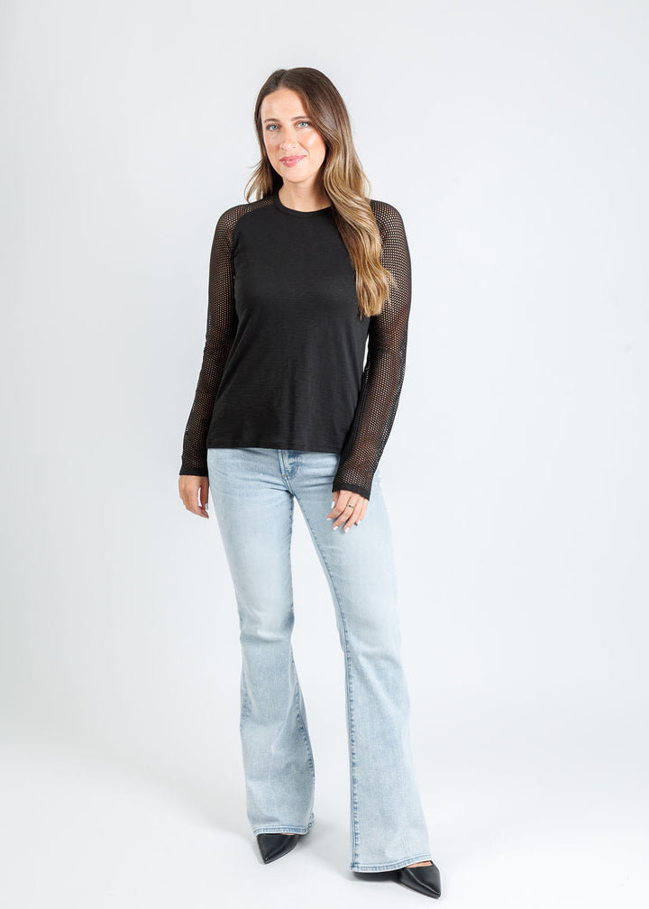 Goldie Soleil Saddle Fishnet Long Sleeve Top in Black paired with Kinsley Mid Rise Ultra Flare Jeans in Serenity available at Barbara Katz