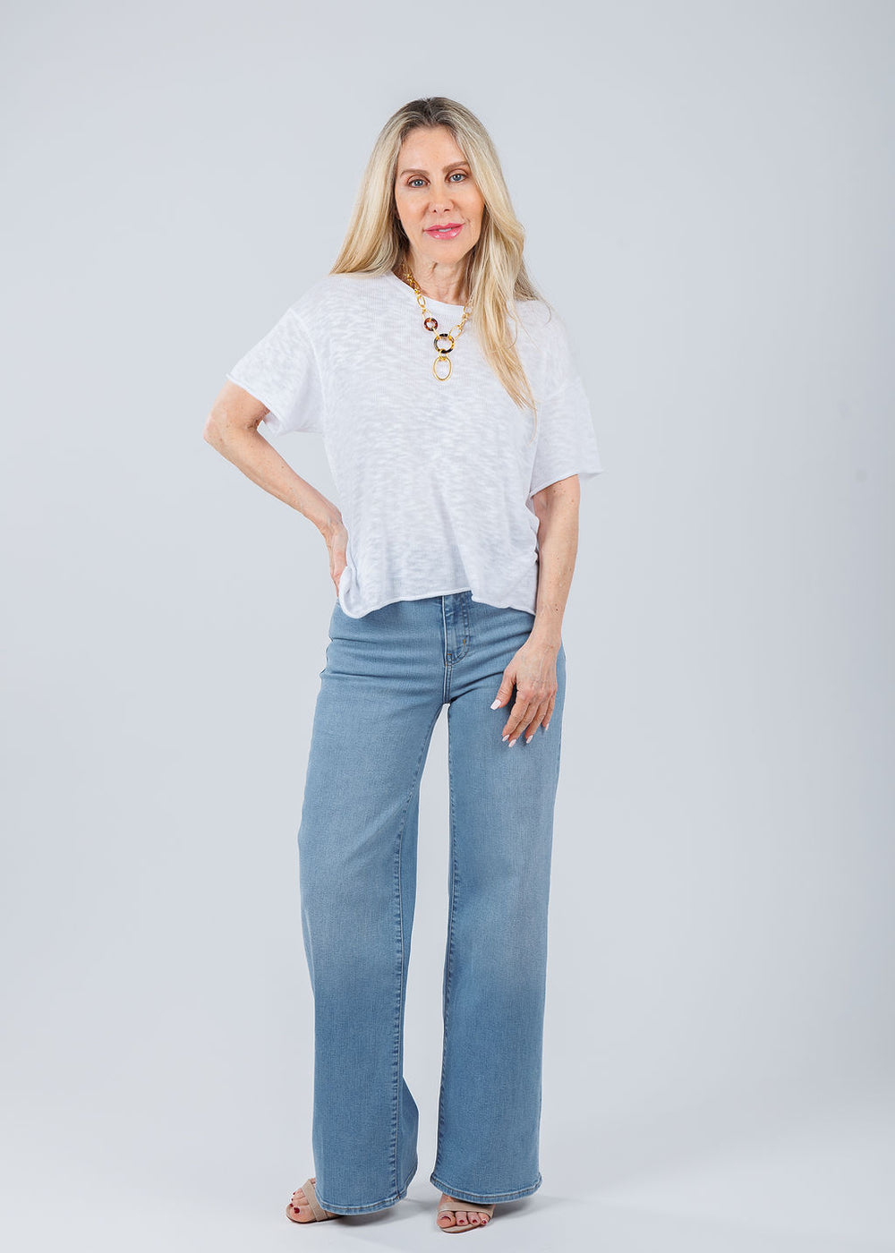 J Society Short Sleeve Boxy Tee in White paired with Frame Le Slim Palazzo Jeans in Honeymoon available at Barbara Katz