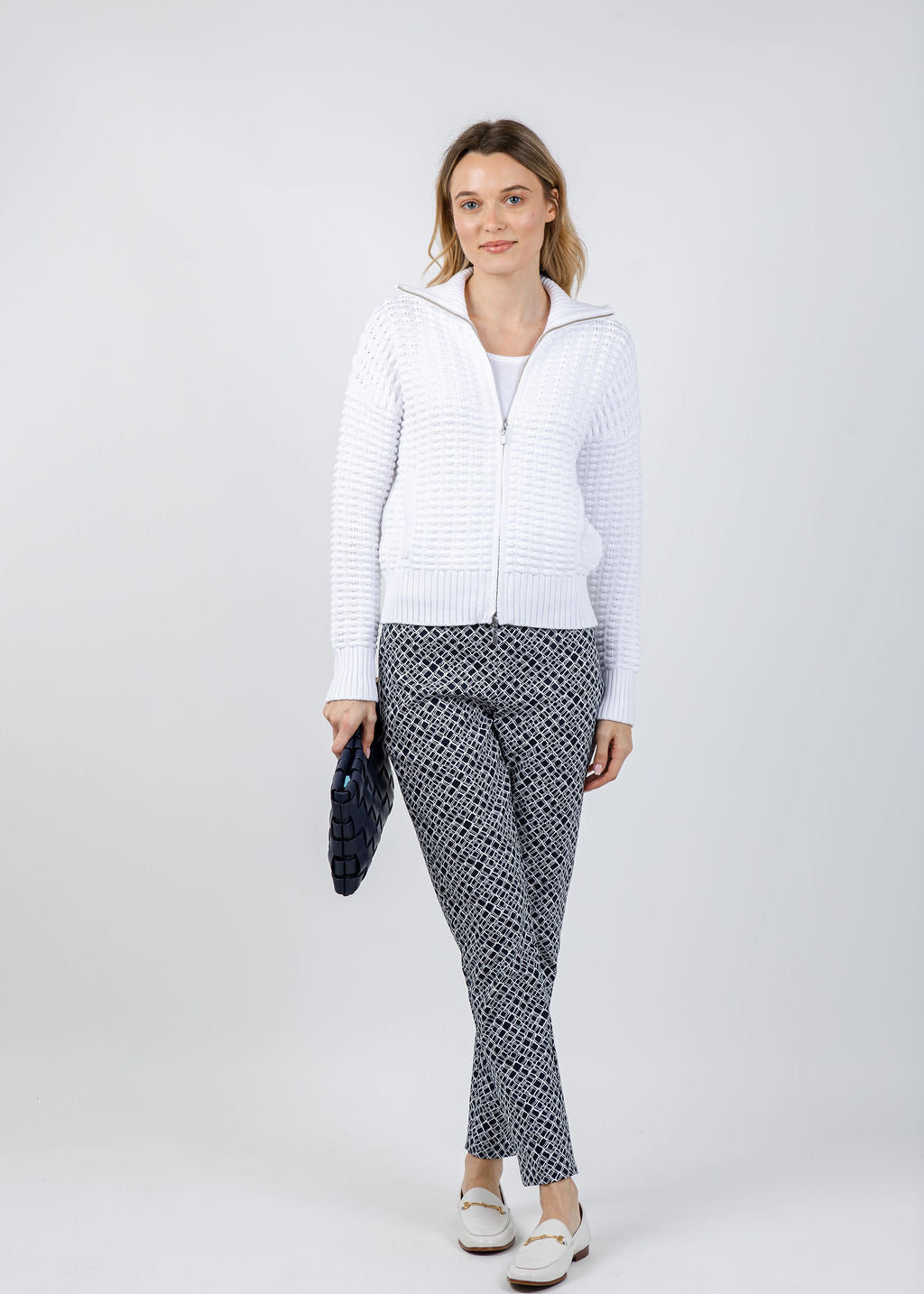 Kinross Bobble Zip Cardigan in White paired with Joseph Ribkoff Geometric Jacquard Pull-On Slim Fit Pants in Navy/White available at Barbara Katz