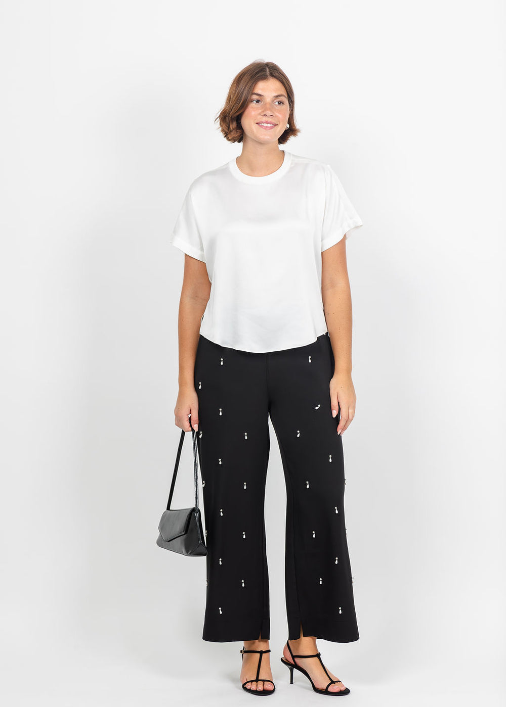 Simkhai Addy Short Sleeve Knit Back T- Shirt in White paired with Lysse Genesis Embellished Stretch Woven Pant in Black available at Barbara Katz