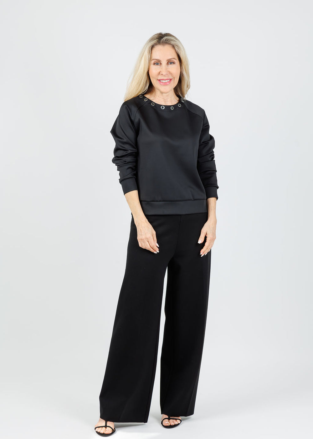 Lysse Desi Grommet Detail Neoprene Pullover in Black paired with Lysse Denver Hi-Waist Wide Leg Pants in Black available at Barbara Katz
