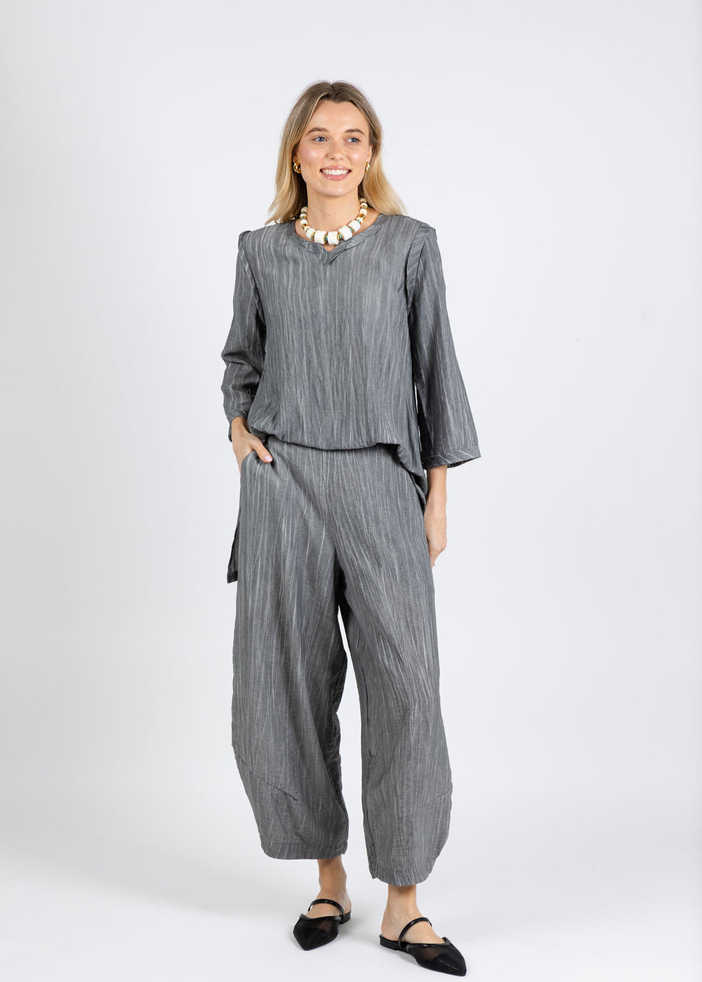 Ozai N Ku Aida V-Neck Tunic in Grey paired with Ozai N Ku Karen Stripe Pants in Grey available at Barbara Katz
