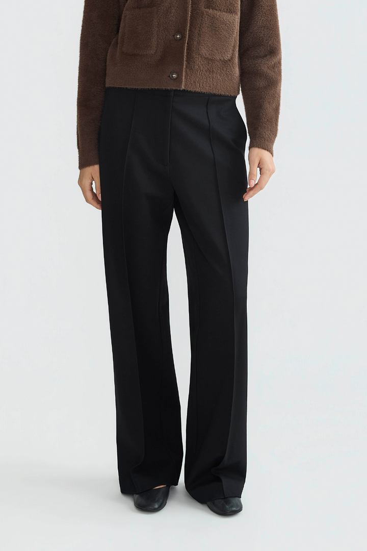 Adroit Atelier Preston Stretch Pin Tuck Ponte Pant With Slant Pockets in Black available at Barbara Katz