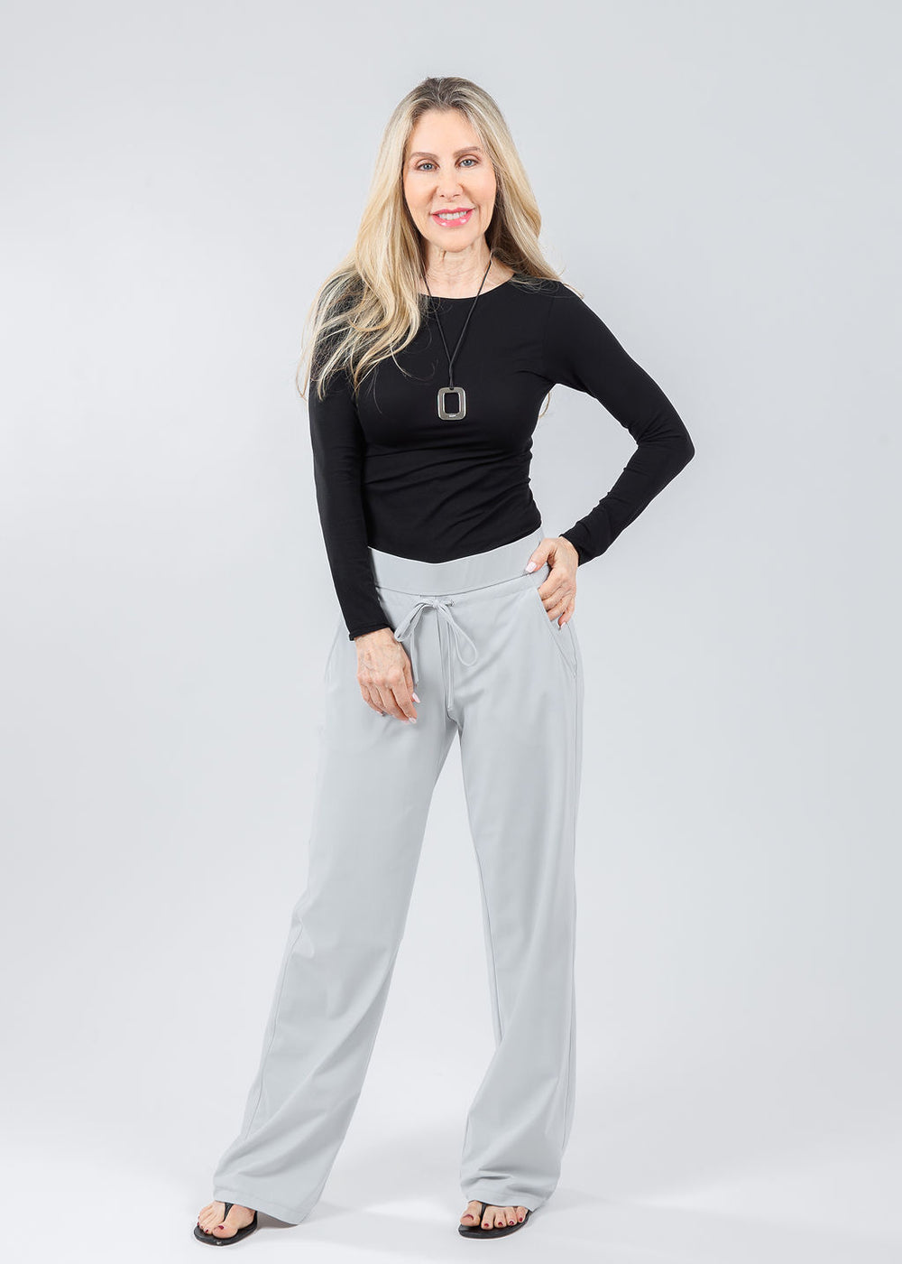 AMB Solid Raw Edge High Neck Second Skin Top in Black paired with Raffaello Rossi Candice Straight Pants in Light Grey available at Barbara Katz