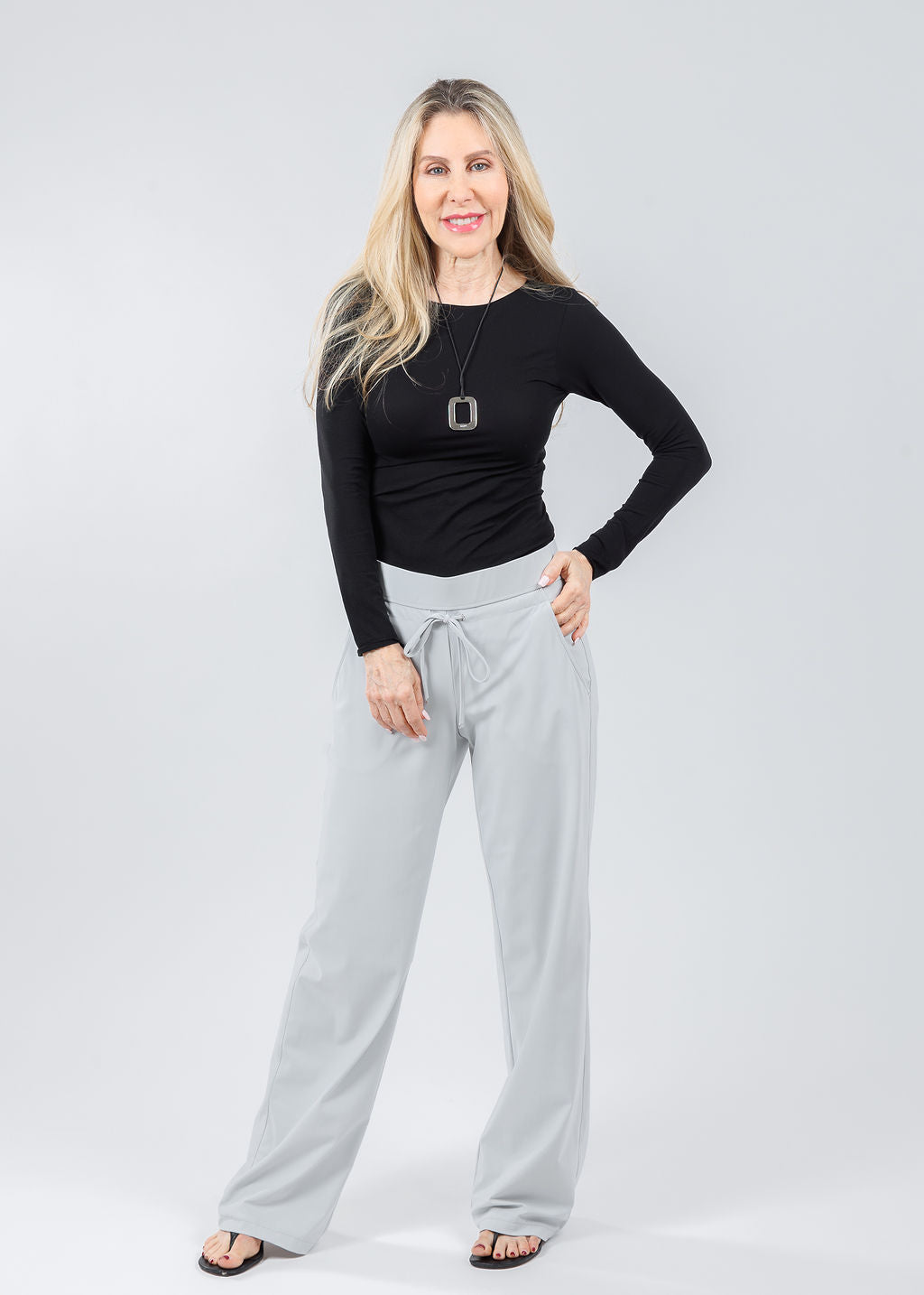 AMB Solid Raw Edge High Neck Second Skin Top in Black paired with Raffaello Rossi Candice Straight Pants in Light Grey available at Barbara Katz