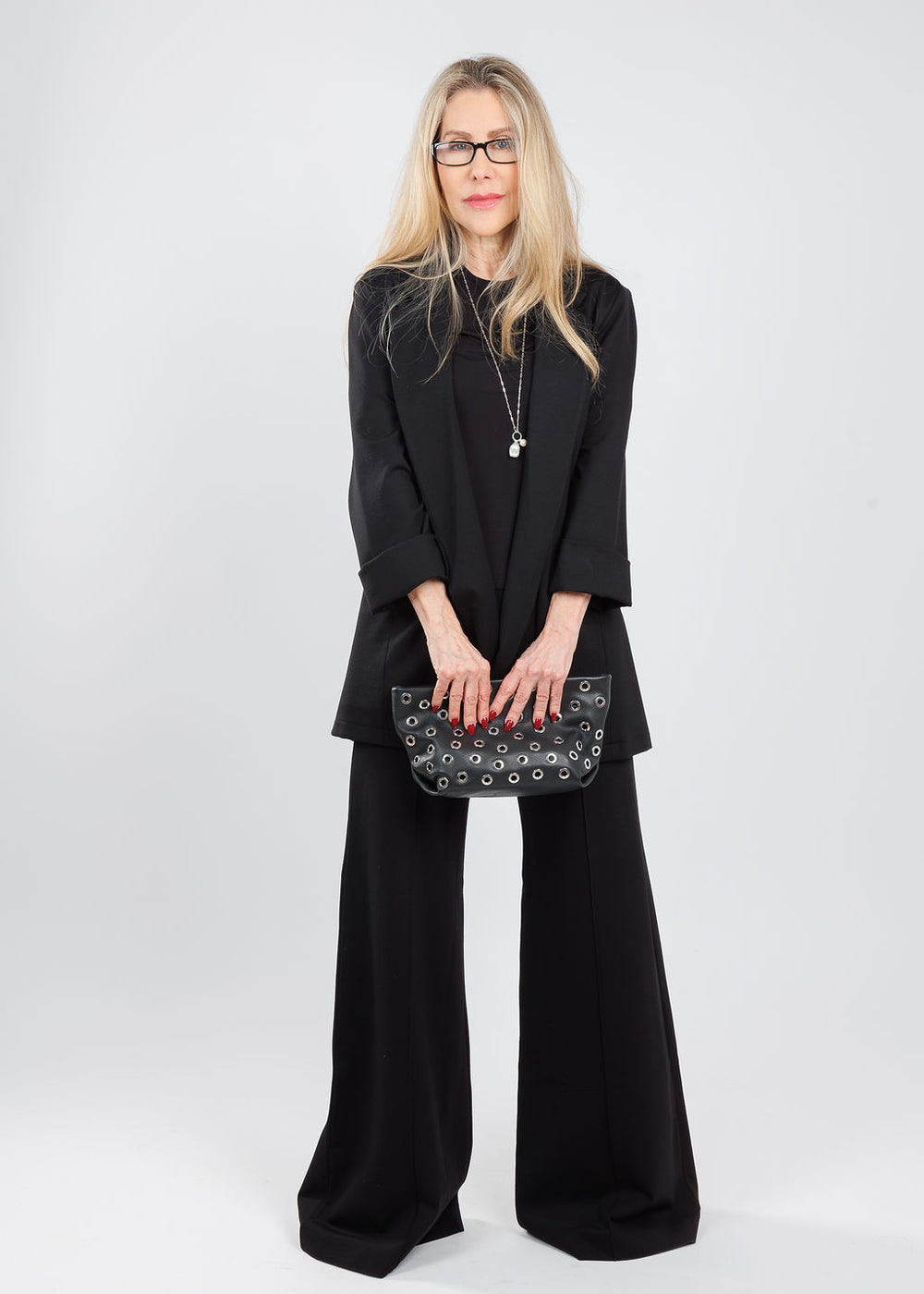 Ripley Rader Ponte Knit Short Sleeve Top & Oversized Blazer in Black paired with matching Ponte Knit Wide Leg Pants, Chan Luu Mona White Pearl Drop Silver Necklace, B-Low the Belt Gia Grommet Clutch Bag in Black Silver, available at Barbara Katz