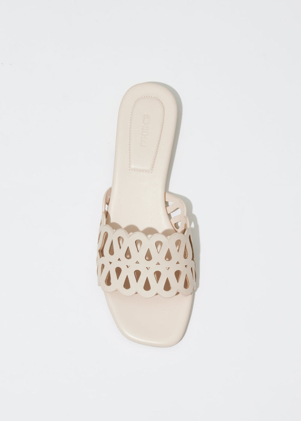 Simkhai Mccall Laser-Cut Leather Flat Slide in Cream available at Barbara Katz