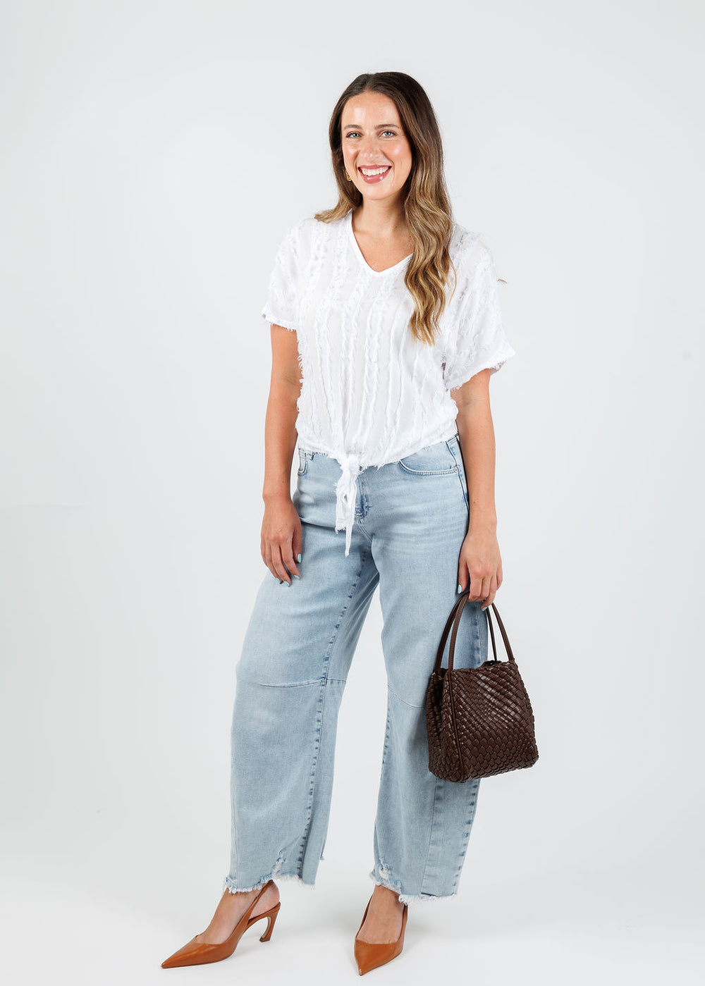 XCVI Curine V-Neck Top in White paired with MAC Dakota Barrel Leg Jeans in Bleached, Remi/Reid Hollace Mini Woven Tote Bag in Espresso available at Barbara Katz
