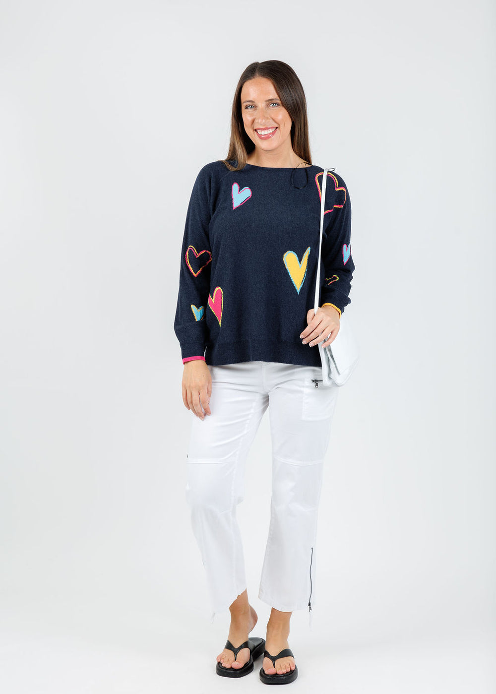 Zaket & Plover Heart Pattern Sweater in Dark Denim paired with Marrakech Cyprus Pants in White available at Barbara Katz